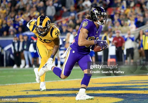 Wide receiver Willie Snead of the Baltimore Ravens runs in a pass for a touchdown over defensive back Marqui Christian of the Los Angeles Rams in the...