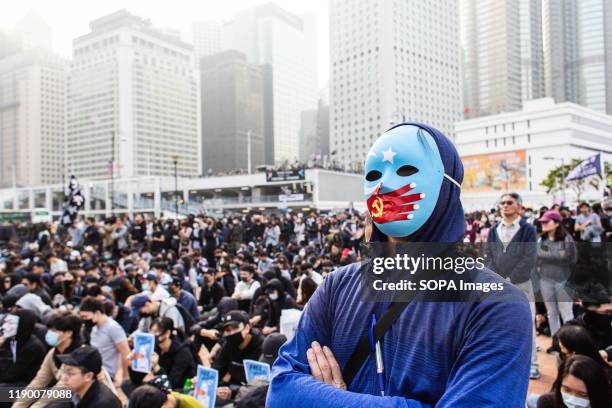 Masked protester looks on during the demonstration. 6th month of civil unrest, protesters attend a rally in solidarity with Uyghurs in Xinjiang....