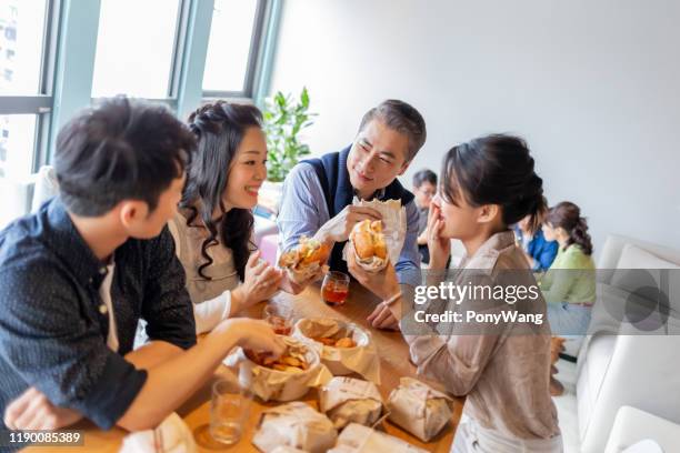 colleagues enjoy their lunch - colleague lunch stock pictures, royalty-free photos & images