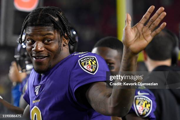 Quarterback Lamar Jackson of the Baltimore Ravens waves from the sidelines during the game against the Los Angeles Rams at Los Angeles Memorial...