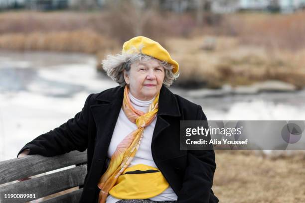 senior woman exercising/ walking in her neighbourhood - widow stock pictures, royalty-free photos & images