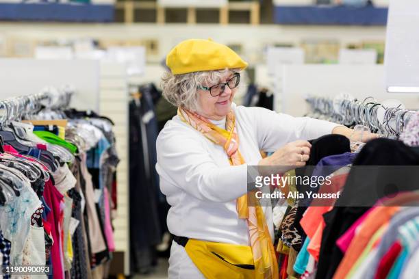 Woman in mid-70s shopping in thrift store