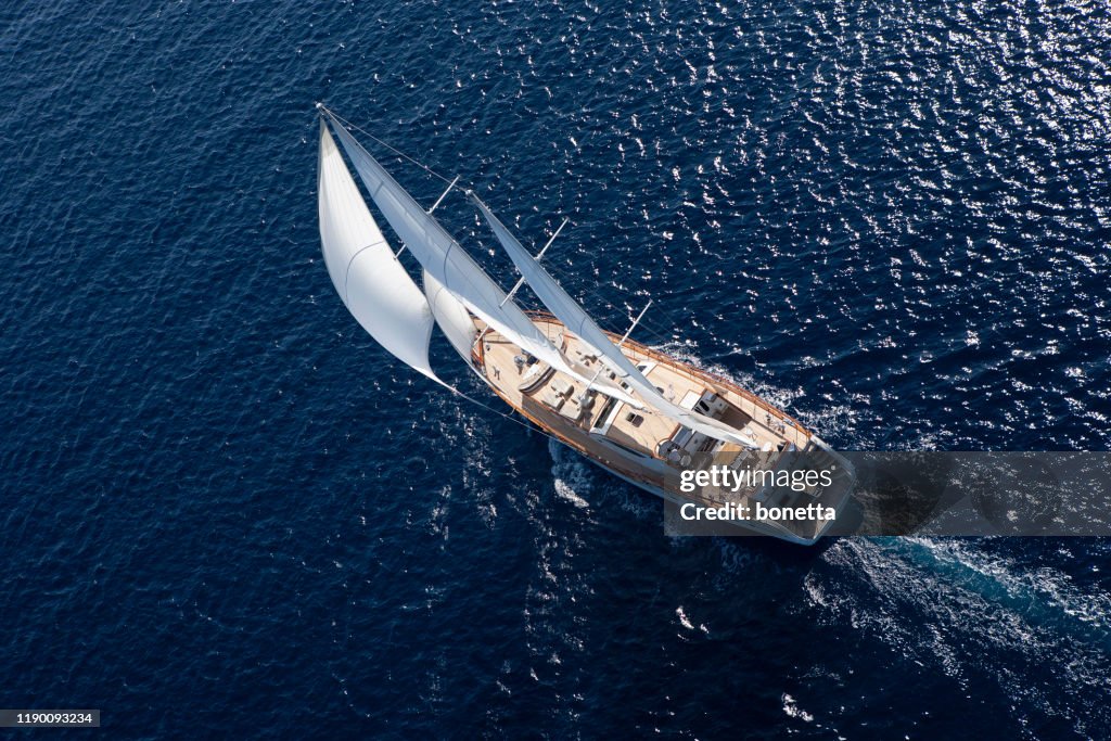 Luxury sailboat sailing in the open blue sea