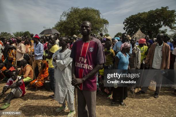 People wait to receive humanitarian aid, first time in nearly a decade, in Yabus town, which is under control of the Sudan People's Liberation...