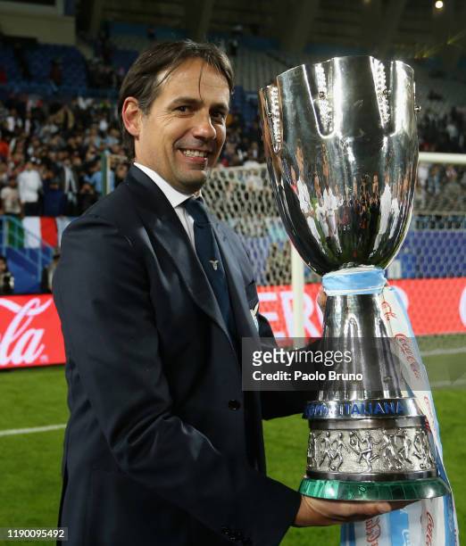 Head coach of SS Lazio Simone Inzaghi celebrates the victory of the Italian Supercup trophy after the Italian Supercup match between Juventus and SS...