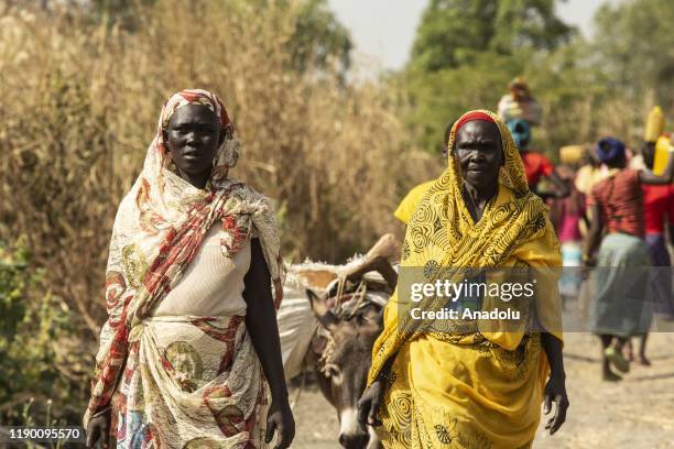 Women carry humanitarian aid, first time in nearly a decade, in Yabus town, which is under control of the Sudan People's Liberation Movement-North ,...