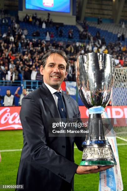 Head coach of SS Lazio Simone Inzaghi celebrates the winning of the Italian Supercup with the trophy after the Italian Supercup match between...
