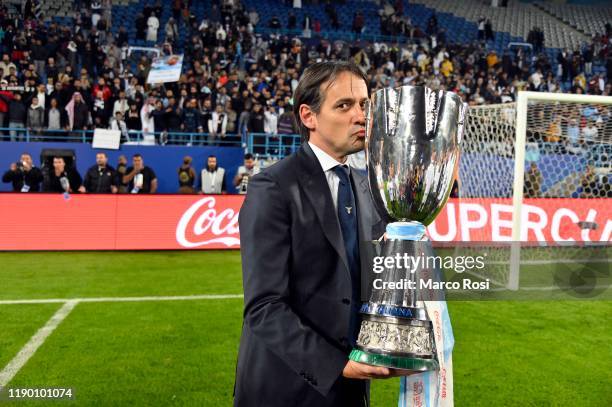 Head coach of SS Lazio Simone Inzaghi celebrates the winning of the Italian Supercup with the trophy after the Italian Supercup match between...