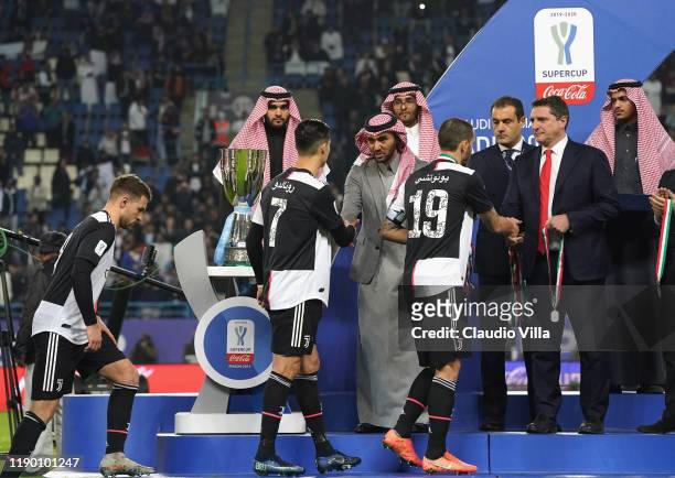 Lega Serie A CEO Luigi De Siervo presents Juventus players with their medals during the medal ceremony after the Italian Supercup match between...