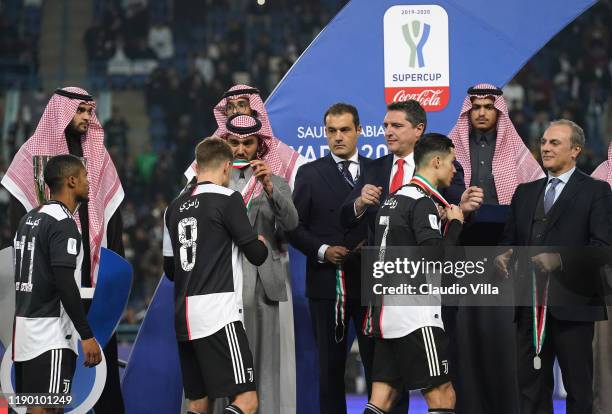 Lega Serie A CEO Luigi De Siervo presents Juventus players with their medals during the medal ceremony after the Italian Supercup match between...