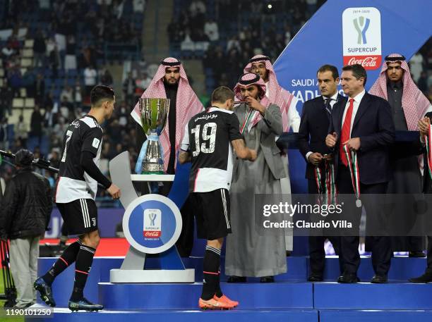 Lega Serie A CEO Luigi De Siervo presents Juventus players with their medals during the medal ceremony after the Italian Supercup match between...