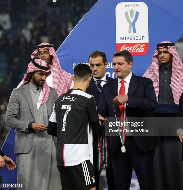 Lega Serie A CEO Luigi De Siervo presents Juventus players with their medals during the medal ceremony after the Italian Supercup match between...