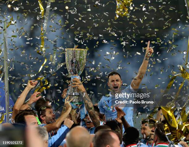 Players of SS Lazio celebrate the victory of the Italian Supercup trophy after the Italian Supercup match between Juventus and SS Lazio at King Saud...