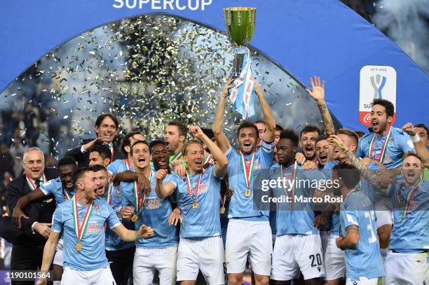 Players of SS Lazio celebrate the winning of Supercup with the trophy after the Italian Supercup match between Juventus and SS Lazio at King Saud...