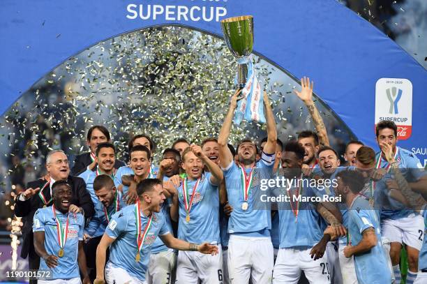 Players of SS Lazio celebrate the winning of Supercup with the trophy after the Italian Supercup match between Juventus and SS Lazio at King Saud...