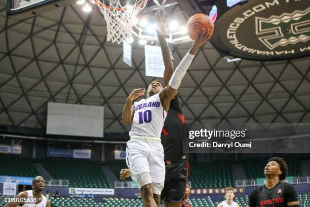 Chase Adams of the Portland Pilots attempts to lay the ball in ahead of Chris Harris Jr. #1 of the Houston Cougars during the second half at the Stan...