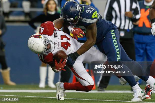 Running back Kenyan Drake of the Arizona Cardinals is tackled by defensive end Branden Jackson of the Seattle Seahawks at CenturyLink Field on...