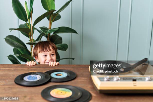 cute child listening to music on table - two turntables stock pictures, royalty-free photos & images