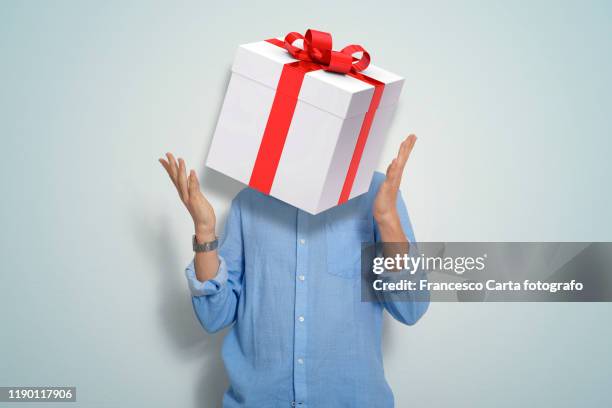 man with a gift package - funny christmas gift stockfoto's en -beelden