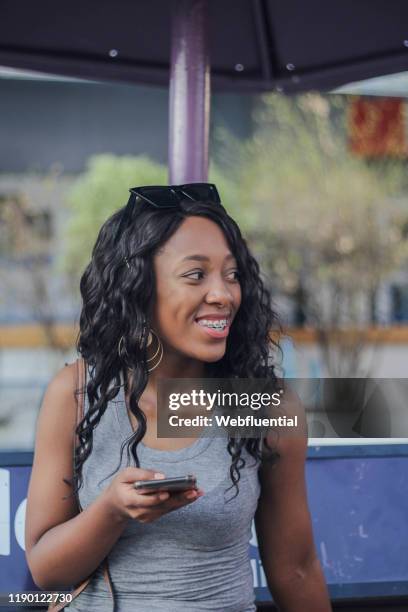 african girl holding smartphone - webfluential bildbanksfoton och bilder
