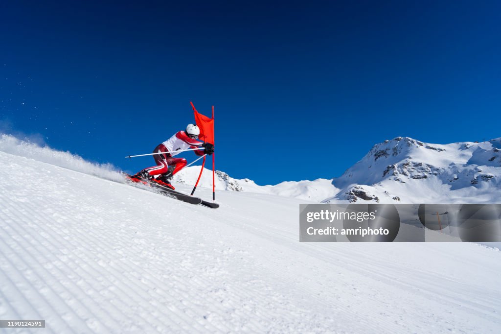 Athlete skier touching goal-spot during super g training