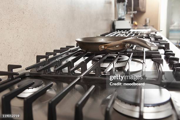 frying pan on hob - gas stove burner stock pictures, royalty-free photos & images