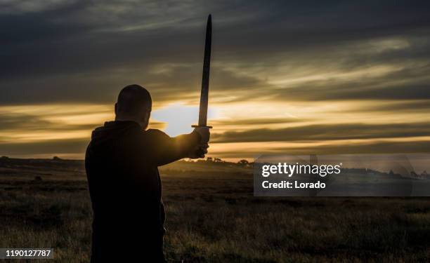 scottish redhead warrior at dawn - sword stock pictures, royalty-free photos & images