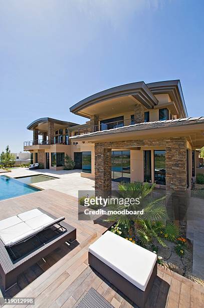 a house exterior with decking, lounge beds and a swimming pool - palm springs california stock pictures, royalty-free photos & images