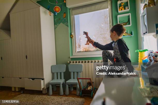 little boy's playing in his room - palaeontologist stock pictures, royalty-free photos & images