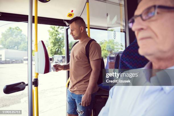 passenger paying fare through contactless payment - fare stock pictures, royalty-free photos & images