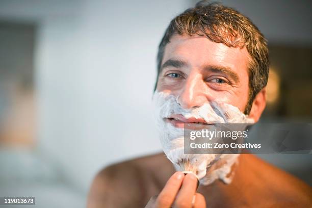 man lathering his face in bathroom - shaving brush fotografías e imágenes de stock