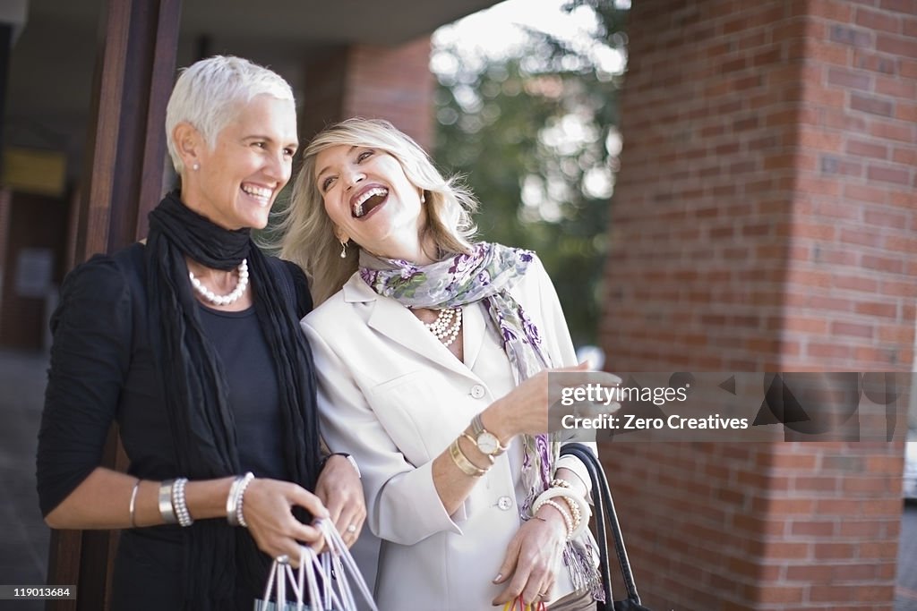 Older women carrying shopping bags