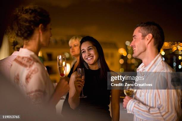 people having wine on terrace at night - 4 cocktails stockfoto's en -beelden