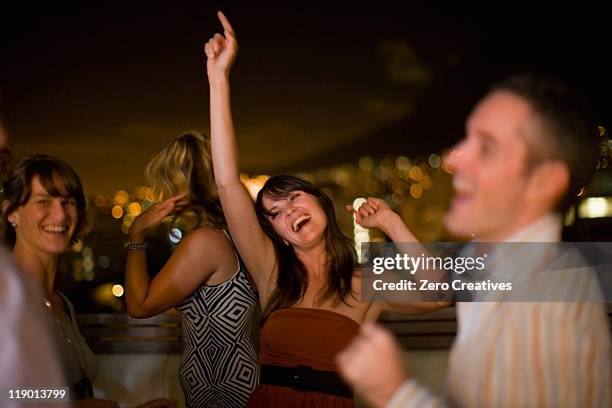 people dancing at party at night - rooftop party night stock pictures, royalty-free photos & images