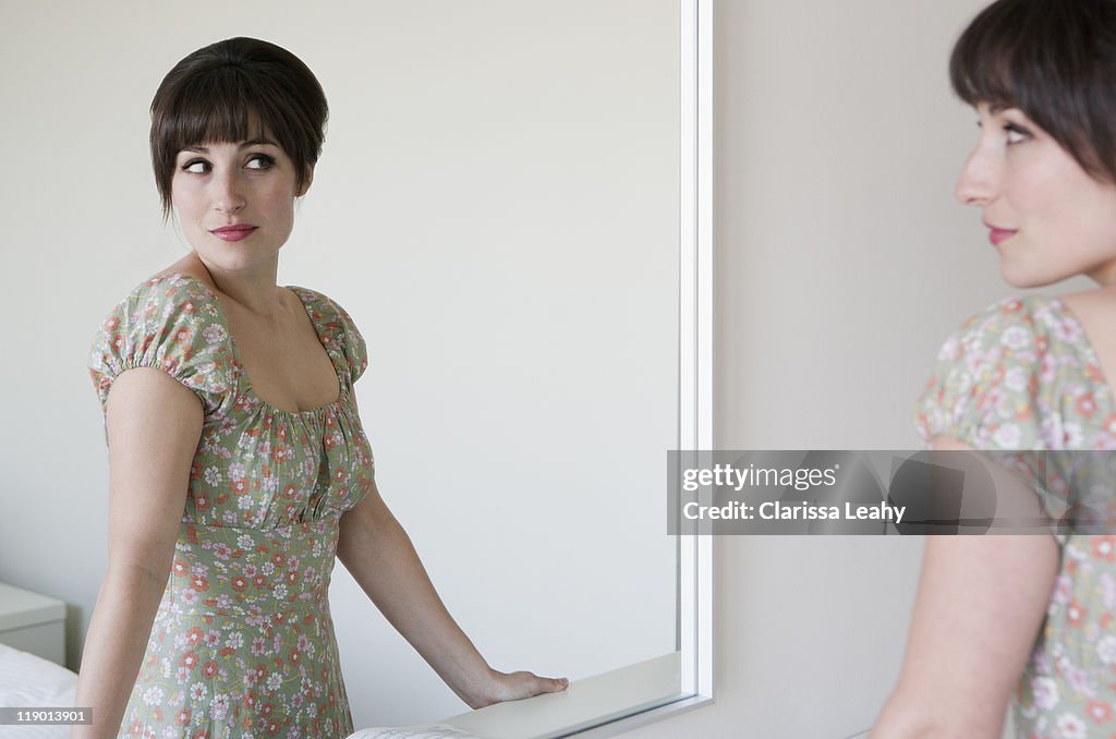 Woman admiring herself in mirror