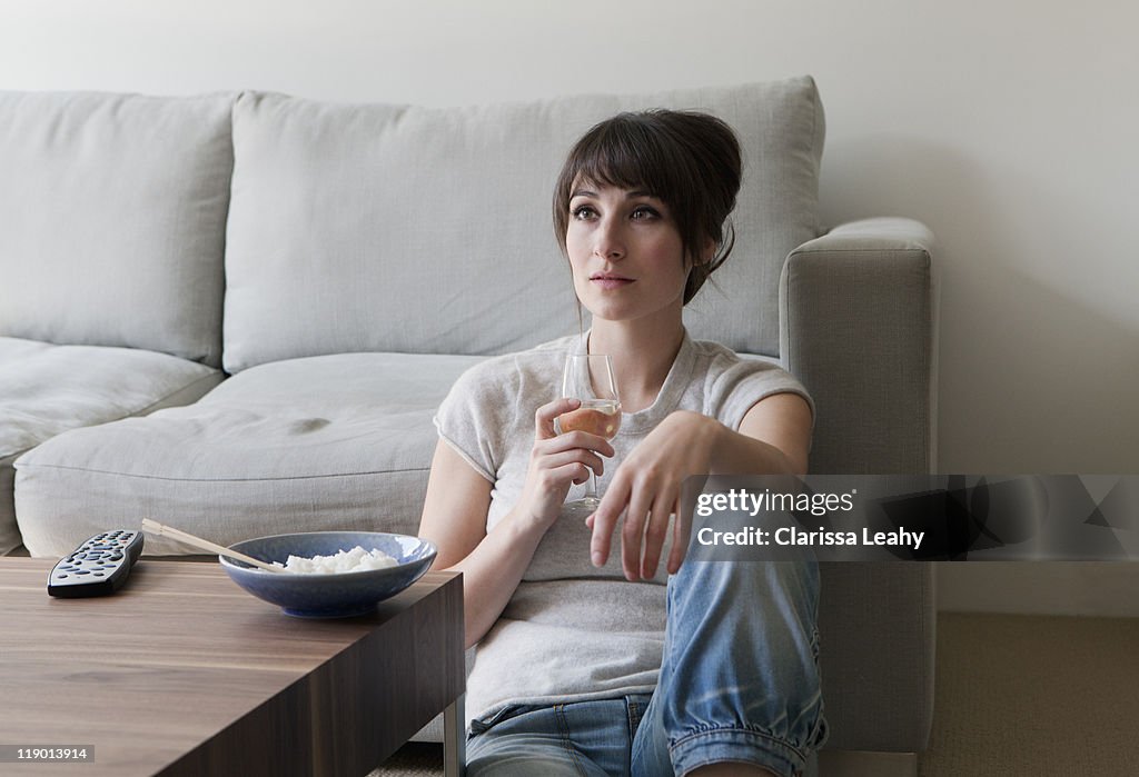 Woman watching television with dinner