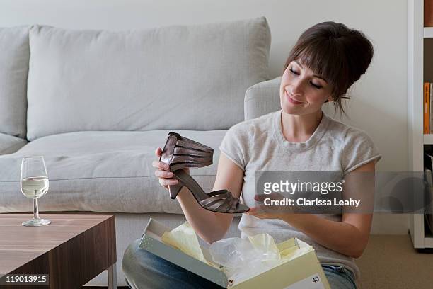 woman admiring new shoe - shoes box stock-fotos und bilder