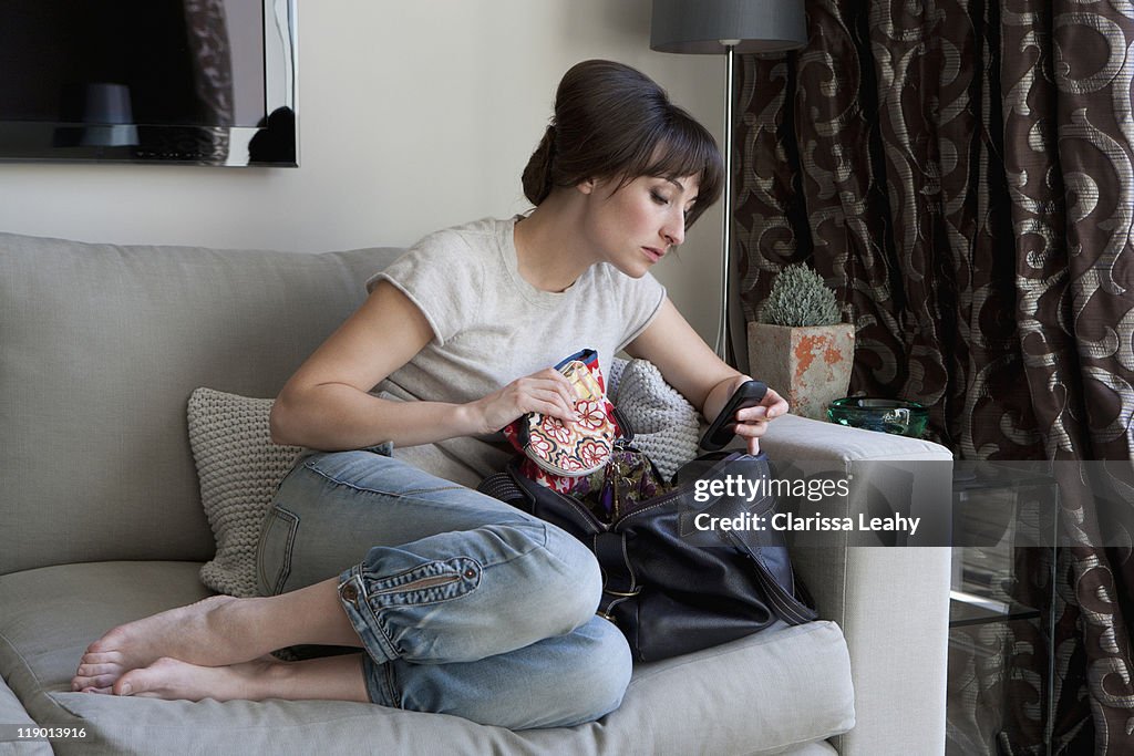 Woman searching contents of purse