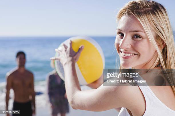 woman playing with ball on beach - woman catching stock pictures, royalty-free photos & images