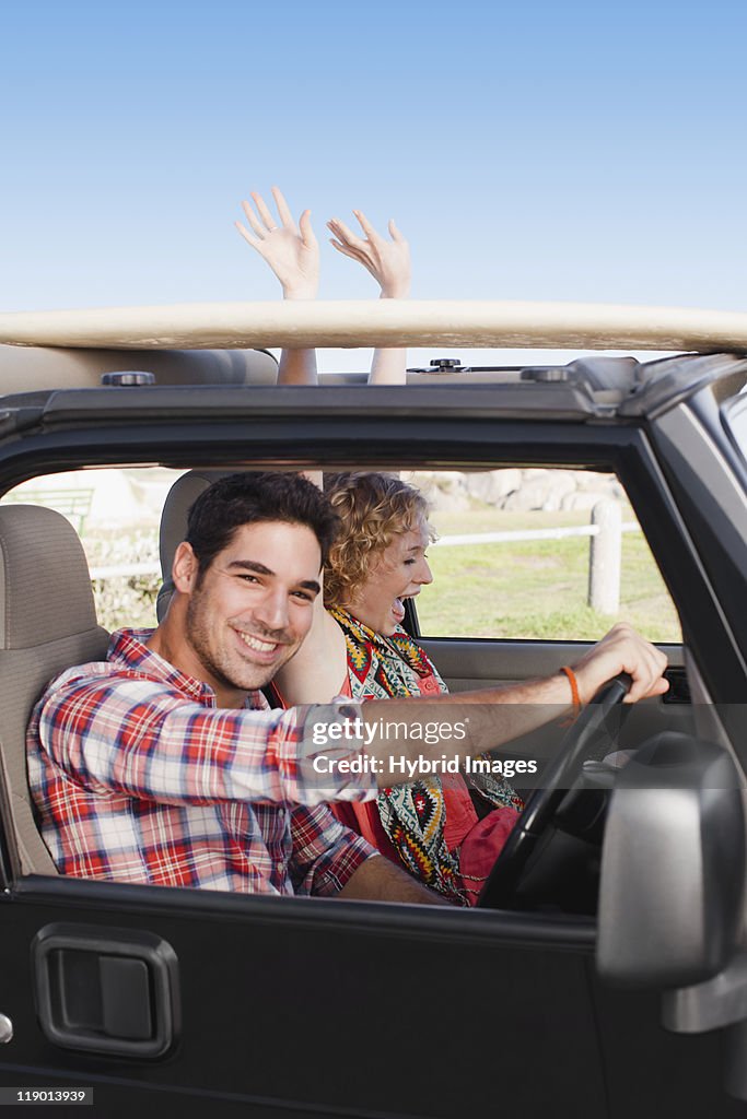 Couple riding in jeep together