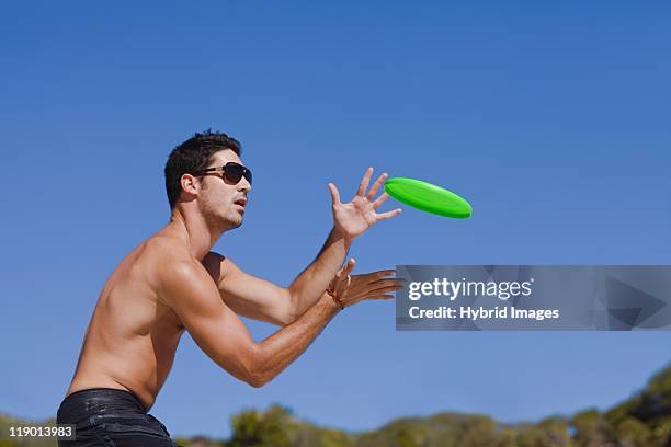 man throwing a frisbee - flying disc stock pictures, royalty-free photos & images