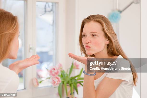 teenage girl blowing kiss in mirror - bavaria girl stock pictures, royalty-free photos & images