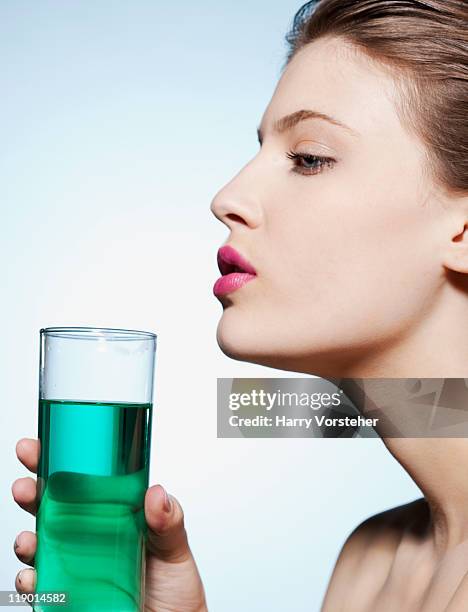 woman holding glass of water - soft drink stock-fotos und bilder