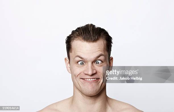 nude man making a funny face - scheel kijken stockfoto's en -beelden