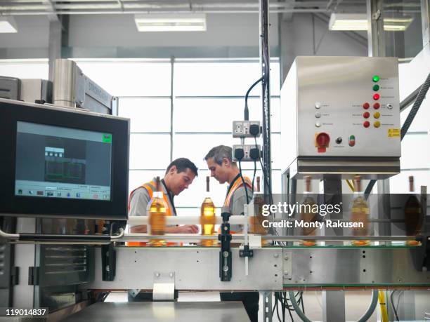 factory workers in bottling plant - bottling plant stock pictures, royalty-free photos & images