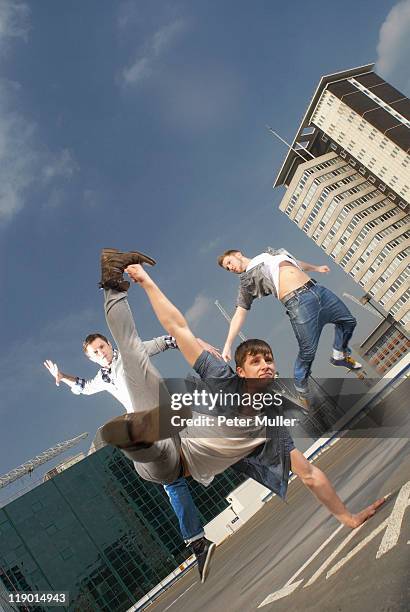 men dancing on urban rooftop - break dance city stock pictures, royalty-free photos & images