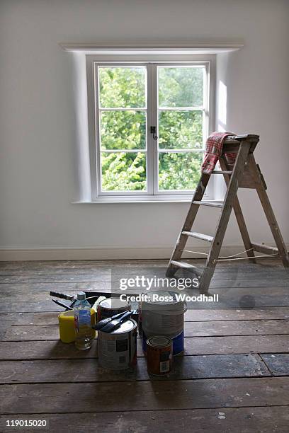 paint cans and ladder in empty house - paint tray fotografías e imágenes de stock