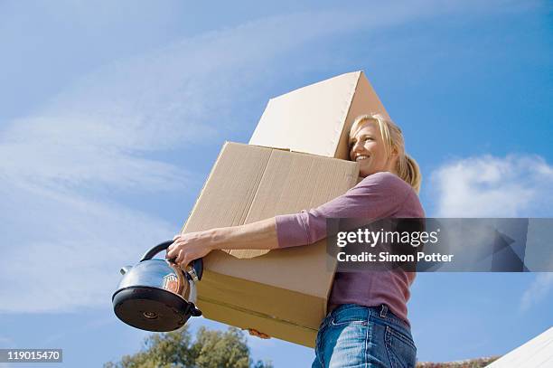 woman carrying cardboard boxes - blue teapot stock pictures, royalty-free photos & images