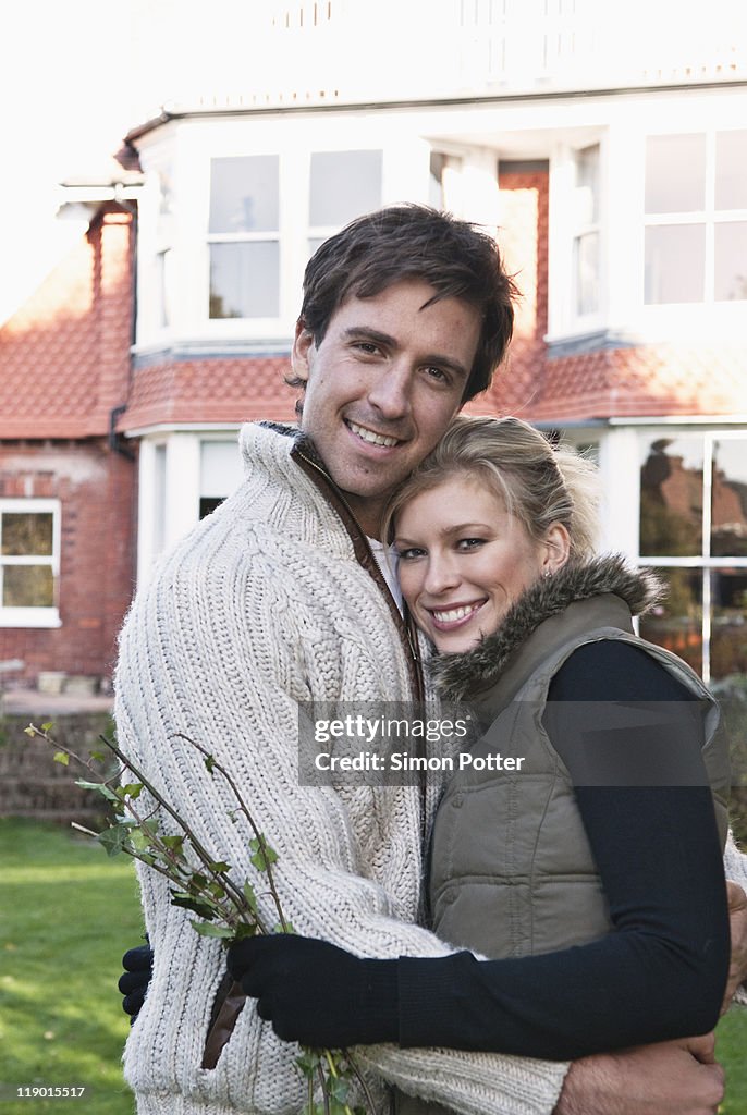 Couple hugging in backyard