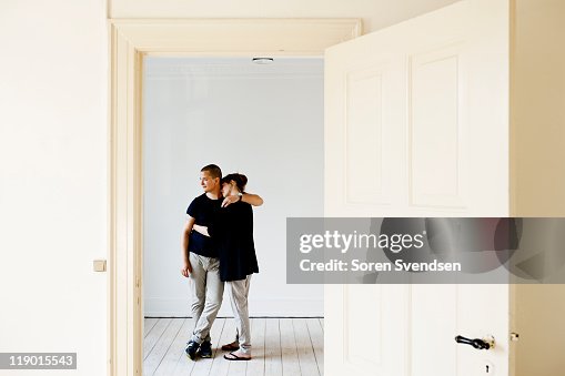 Couple hugging in new home Couple hugging in new home
